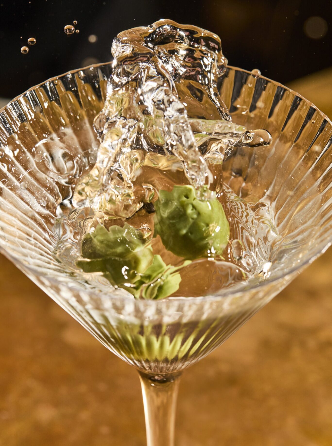 Martini with splash from olive dropping